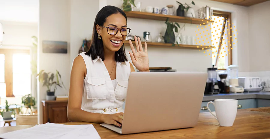 Mulher acenando para o computador, representando o  registro de ponto remoto